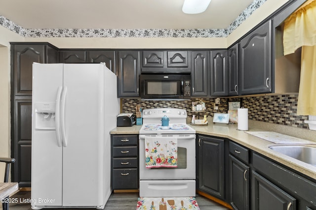 2410 Mammoth Way, Louisville, KY 40299 - kitchen with tasteful backsplash, light countertops, white appliances, and wood finished floors