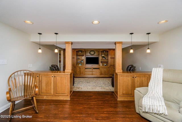 interior space with dark wood-style floors, recessed lighting, ornate columns, and pendant lighting