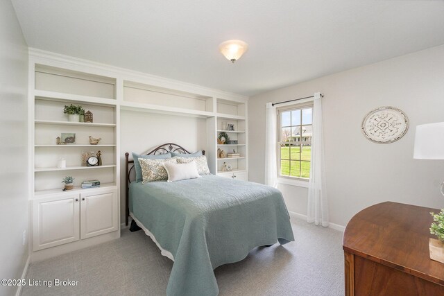 bedroom with light carpet and baseboards