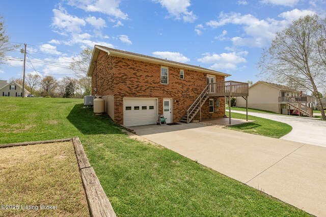 exterior space featuring stairway, an attached garage, driveway, a lawn, and brick siding