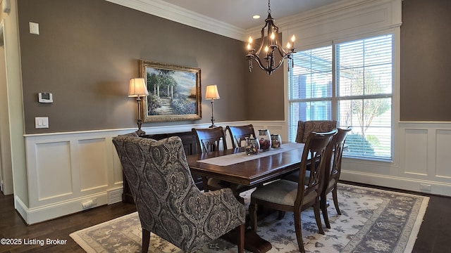 dining room featuring a chandelier, wainscoting, and dark wood-style flooring