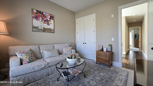 living room with baseboards and wood finished floors