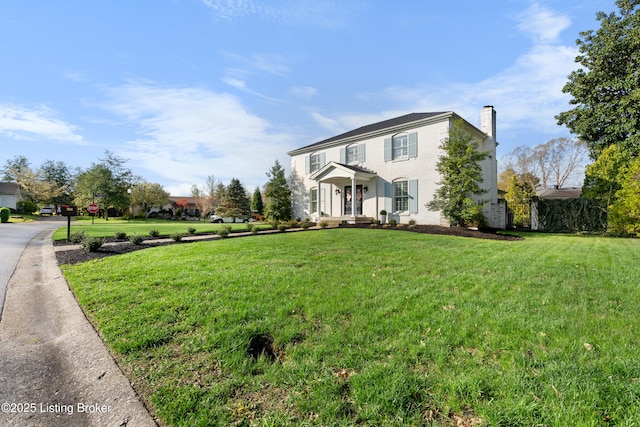 view of home's exterior with a lawn and a chimney