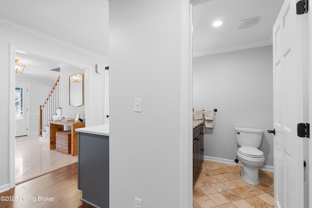bathroom featuring vanity, ornamental molding, recessed lighting, toilet, and baseboards