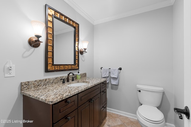 half bathroom featuring crown molding, vanity, toilet, baseboards, and stone tile flooring