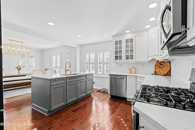 kitchen featuring a sink, gray cabinets, appliances with stainless steel finishes, and dark wood-type flooring