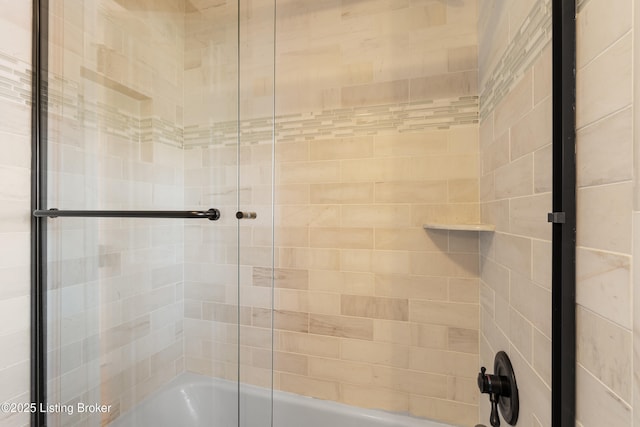 bathroom featuring bath / shower combo with glass door