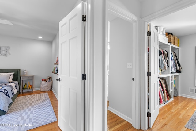 bedroom featuring recessed lighting, light wood finished floors, visible vents, and baseboards