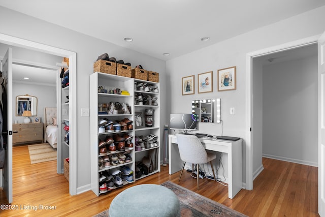 office with baseboards, light wood-type flooring, and recessed lighting