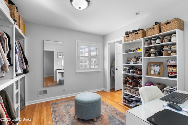 spacious closet featuring visible vents and wood finished floors