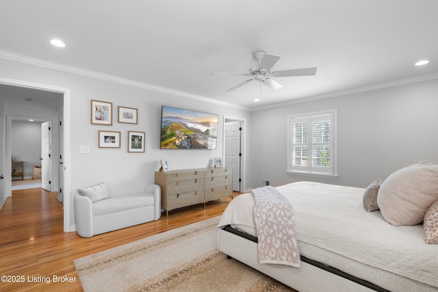 bedroom with wood finished floors, ornamental molding, and recessed lighting