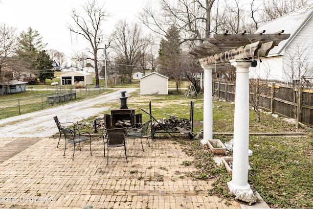 138 E Main St, Glendale, KY 42740 - view of patio with fence, a fire pit, a pergola, and an outbuilding