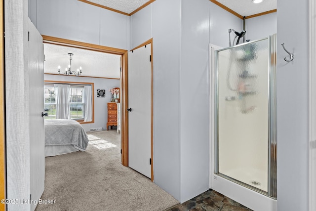 ensuite bathroom with crown molding, a notable chandelier, a stall shower, and ensuite bath