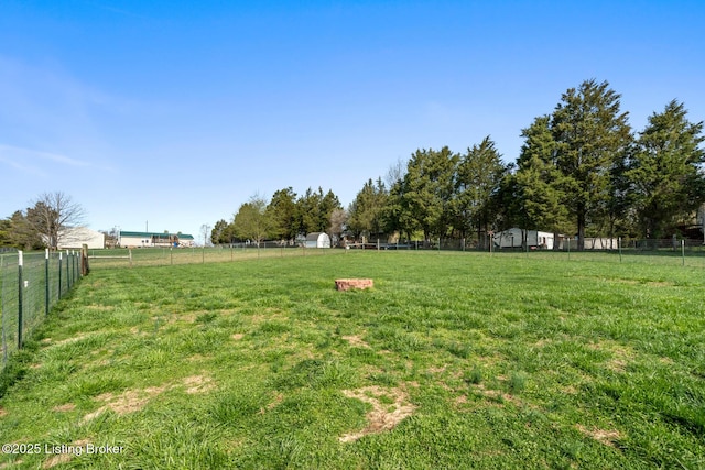 view of yard with a rural view and fence