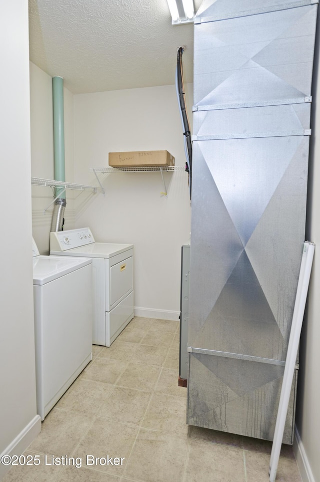 591 Arrowhead Ln, Shepherdsville, KY 40165 - clothes washing area with baseboards, washer and clothes dryer, laundry area, and a textured ceiling