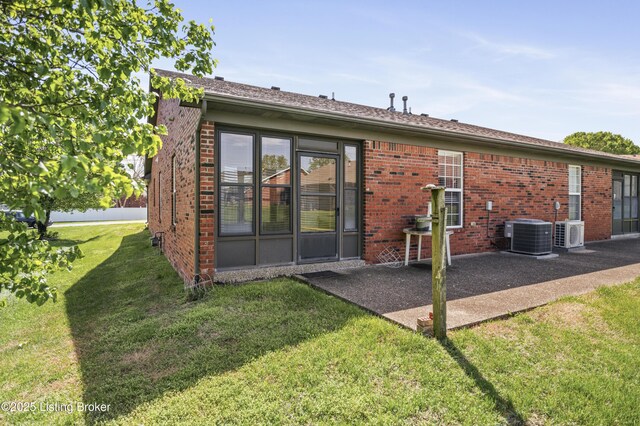 591 Arrowhead Ln, Shepherdsville, KY 40165 - back of property with brick siding, a yard, central AC unit, and a patio area