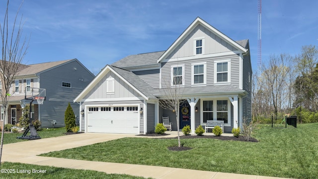 traditional-style home featuring a front lawn, concrete driveway, board and batten siding, an attached garage, and covered porch