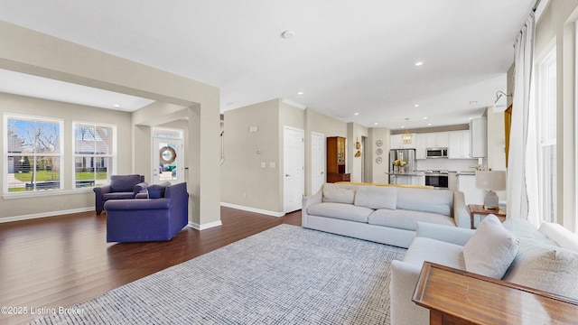 living room with baseboards, dark wood-style flooring, and recessed lighting