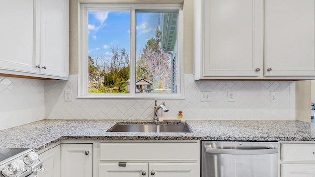 kitchen with stove, dishwasher, white cabinetry, and a sink