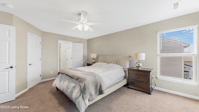 bedroom featuring baseboards, visible vents, a ceiling fan, and light colored carpet