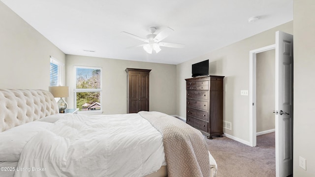 bedroom with light colored carpet, baseboards, a ceiling fan, and visible vents