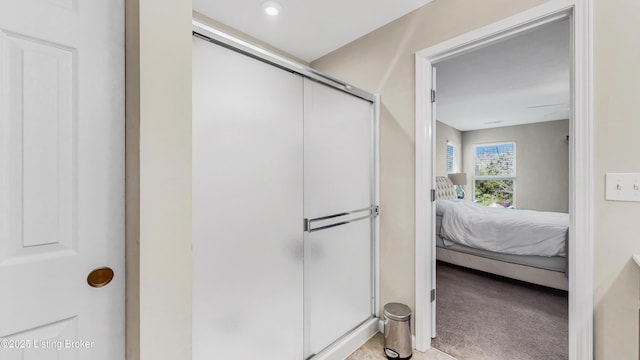ensuite bathroom featuring ensuite bathroom and a shower stall