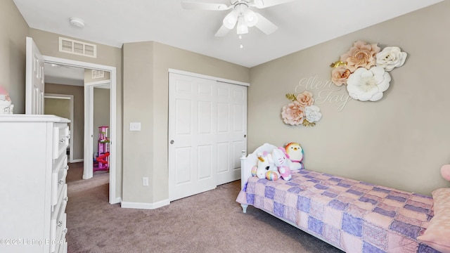 carpeted bedroom with a closet, visible vents, baseboards, and ceiling fan