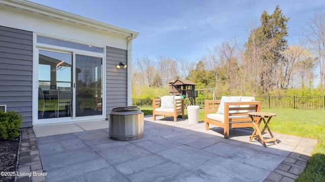 view of patio / terrace featuring fence and a playground