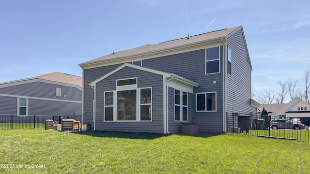 back of house featuring a lawn and fence