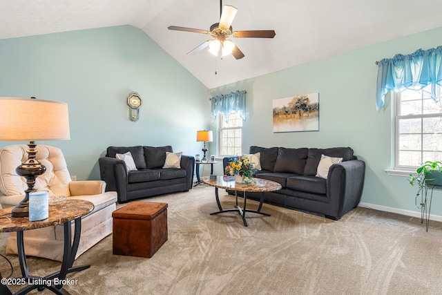 carpeted living area with baseboards, vaulted ceiling, a ceiling fan, and plenty of natural light