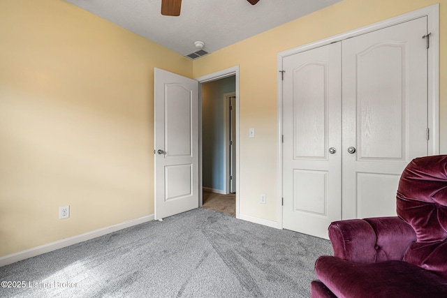 living area with visible vents, carpet floors, ceiling fan, and baseboards