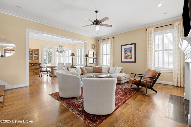 9502 Gerardia Ln, Prospect, KY 40059 - living area with a chandelier, crown molding, light wood-style floors, baseboards, and ceiling fan