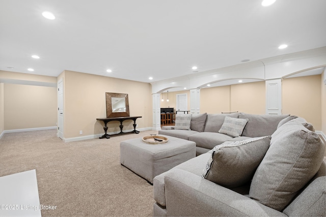 9502 Gerardia Ln, Prospect, KY 40059 - living area with ornate columns, arched walkways, recessed lighting, light carpet, and baseboards