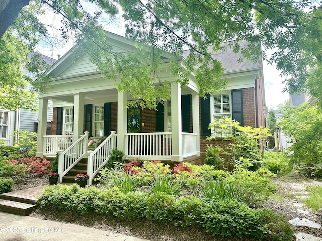 9502 Gerardia Ln, Prospect, KY 40059 - view of front facade with brick siding, a porch, and a shingled roof