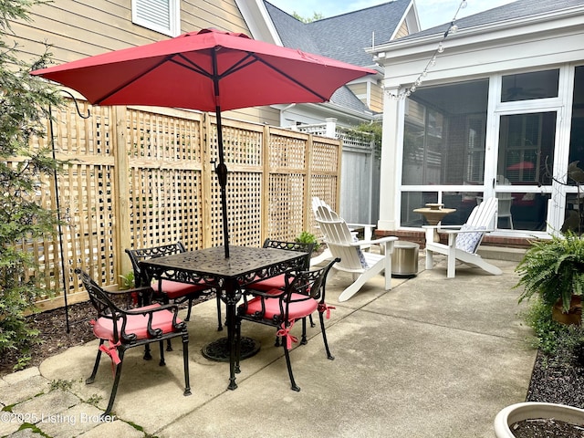 9502 Gerardia Ln, Prospect, KY 40059 - view of patio featuring outdoor dining area, a sunroom, and fence