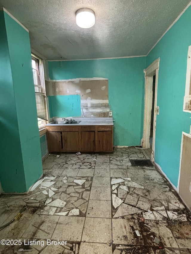 interior space featuring a textured ceiling and a sink