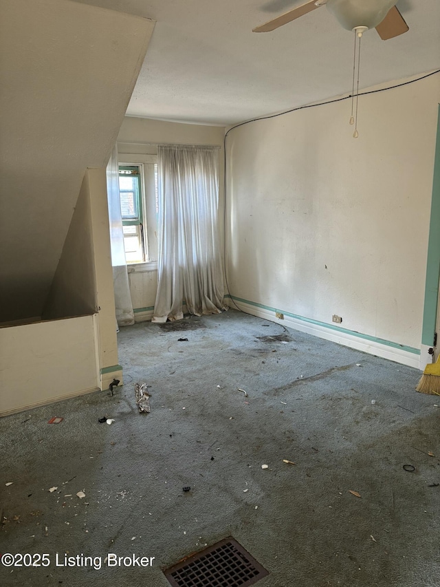 bonus room featuring baseboards and a ceiling fan