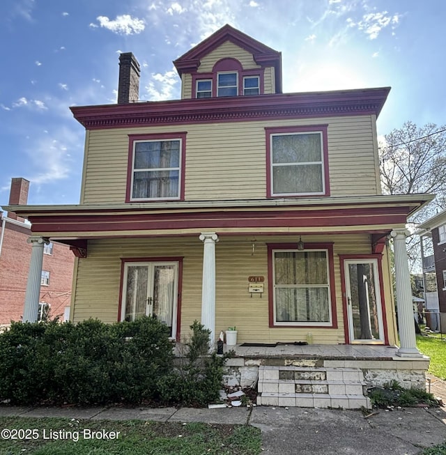 view of front of property featuring a porch and a chimney