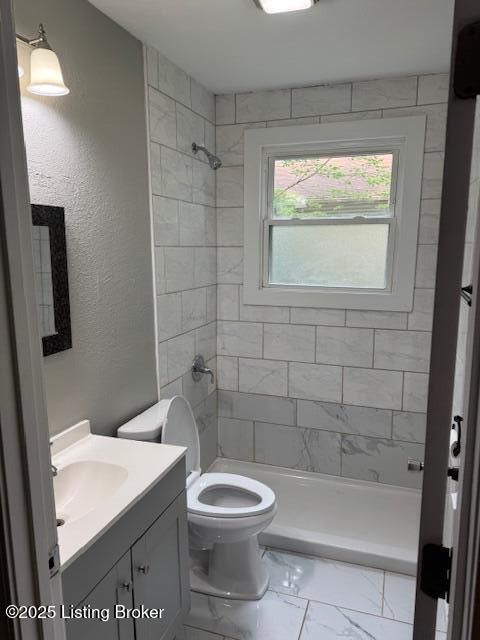 715 W Evelyn Ave, Louisville, KY 40215 - bathroom with marble finish floors, a stall shower, vanity, and toilet