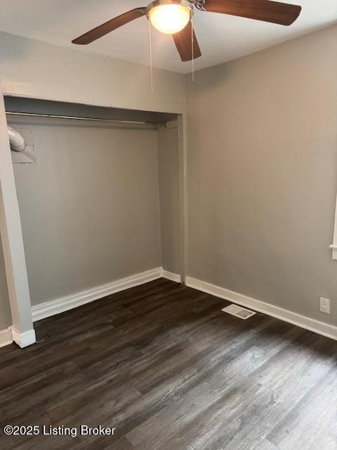 715 W Evelyn Ave, Louisville, KY 40215 - unfurnished bedroom featuring dark wood-type flooring, baseboards, and ceiling fan