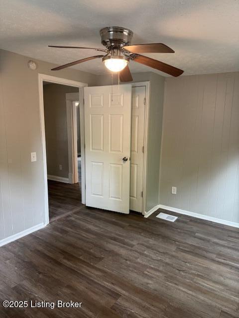 715 W Evelyn Ave, Louisville, KY 40215 - unfurnished room with baseboards, ceiling fan, and dark wood-style floors