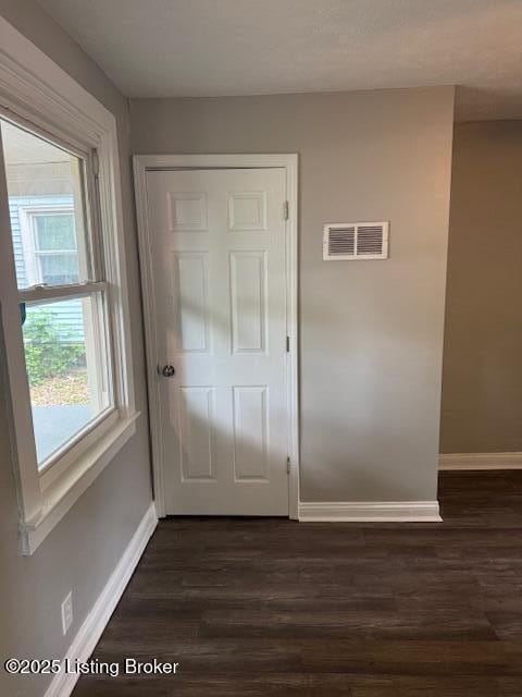 715 W Evelyn Ave, Louisville, KY 40215 - doorway with baseboards and dark wood finished floors