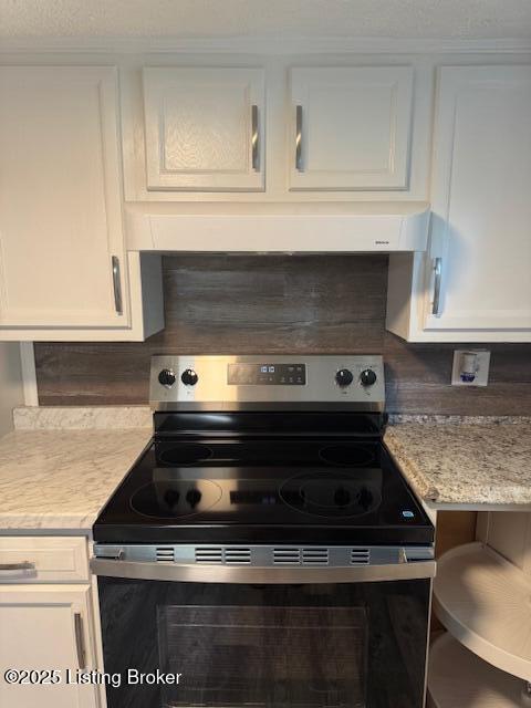 715 W Evelyn Ave, Louisville, KY 40215 - kitchen with electric range, white cabinets, extractor fan, and light stone countertops