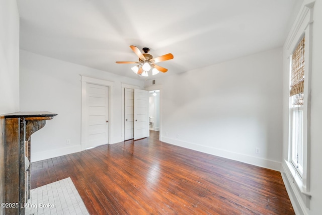 unfurnished living room with baseboards, a ceiling fan, and hardwood / wood-style flooring