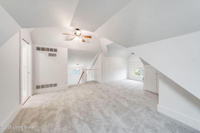 bonus room featuring baseboards, carpet flooring, a ceiling fan, visible vents, and lofted ceiling