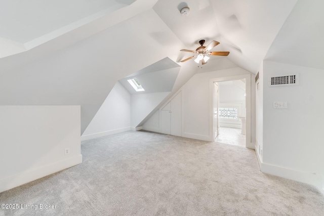bonus room with a ceiling fan, vaulted ceiling, visible vents, carpet floors, and baseboards