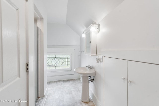 bathroom with an enclosed shower and lofted ceiling