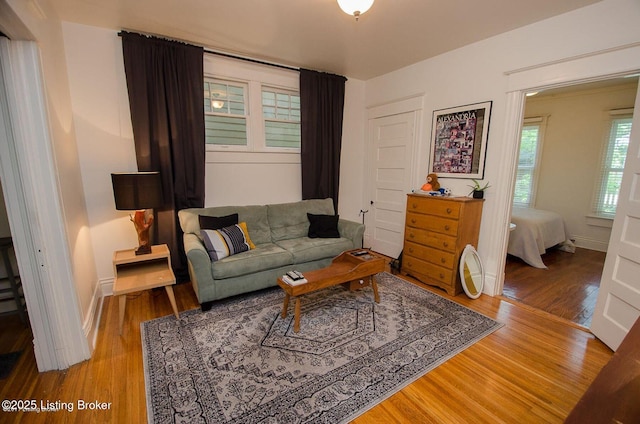 living room featuring wood finished floors and baseboards