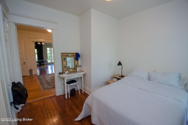 bedroom with wood finished floors and baseboards