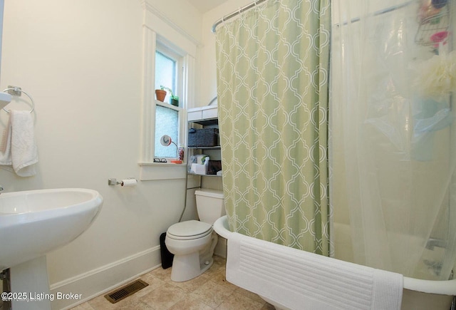 full bathroom featuring shower / tub combo, baseboards, toilet, visible vents, and a sink